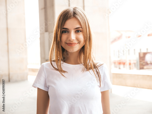 Portrait of beautiful blond model dressed in summer hipster clothes. Trendy girl posing in the street background. Funny and positive woman having fun