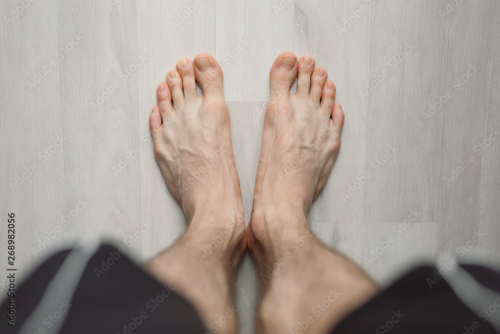 POV, man barefoot on the floor, male legs Stock Photo | Adobe Stock