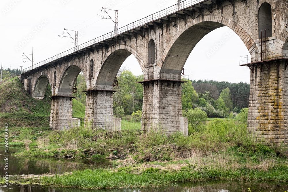 Old rail road bridge  under the river . Old brick construction.