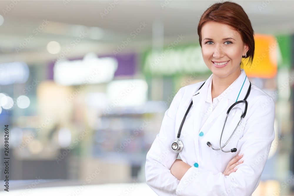 Attractive young female doctor on background Attractive young female doctor on background