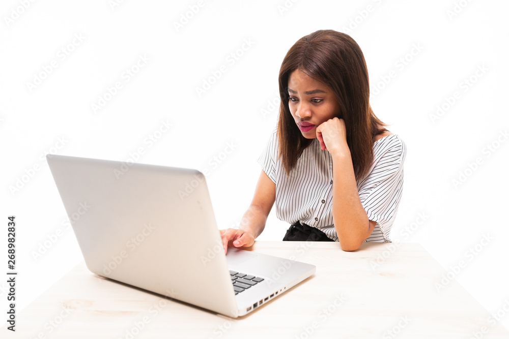 dark-skinned young girl typing on the laptop isolated on background dark-skinned young girl typing on the laptop isolated on background