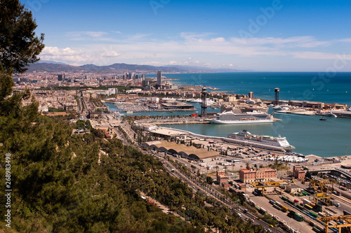 Photography Aerial view of Barcelona city over Port Vell Marina and Barceloneta District fro