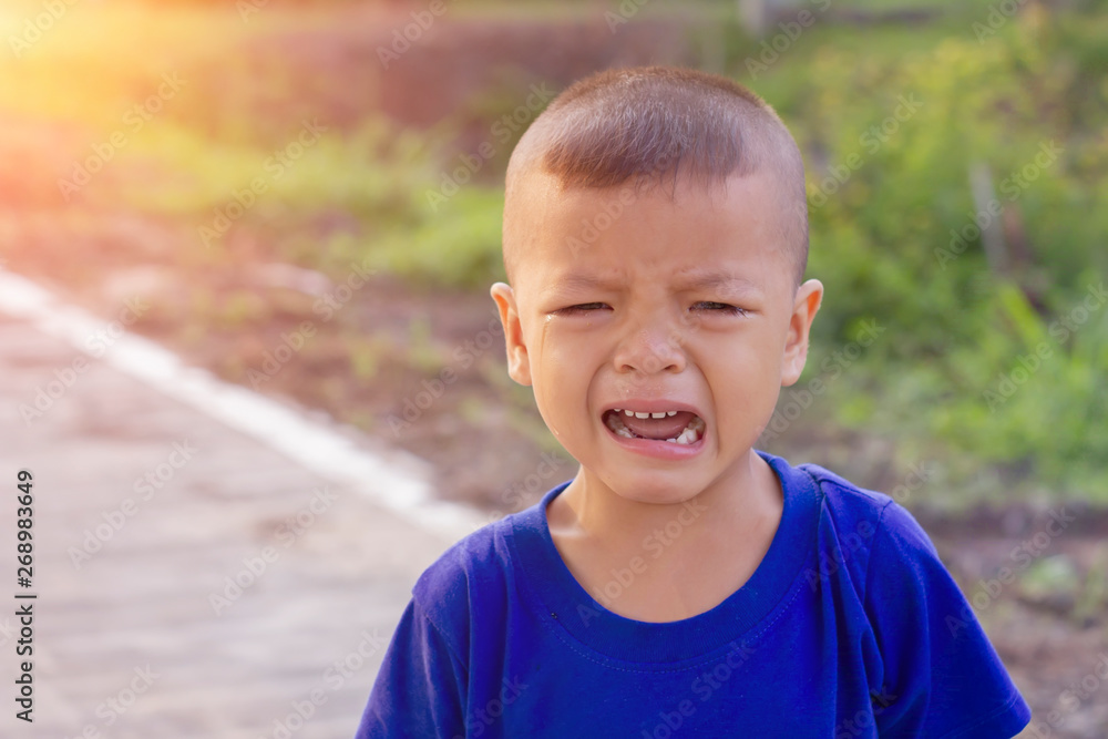 Asian boy crying on the street Asian boy crying on the street