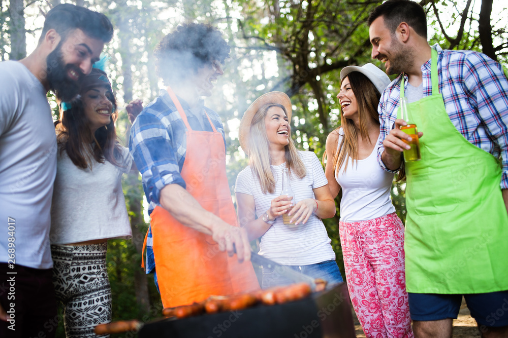 Group of friends having a barbecue party in nature