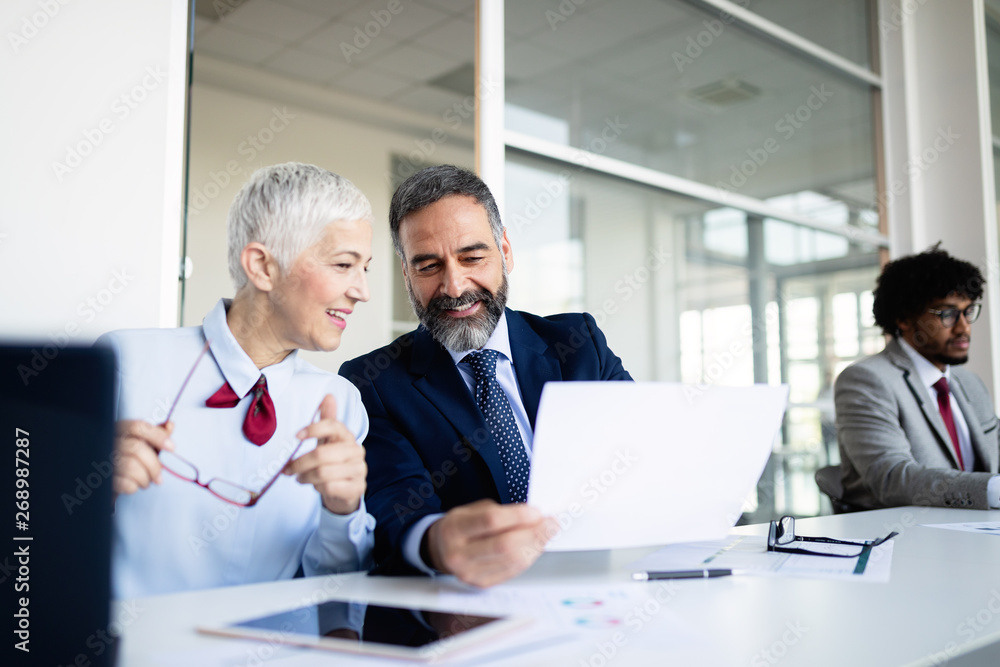 Happy mature businessman and businesswoman planning in office Happy mature businessman and businesswoman planning in office