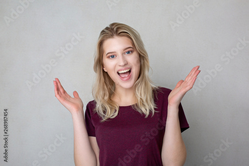 Wallpaper Mural Excited smiling young woman spreading hands. Space for text Torontodigital.ca