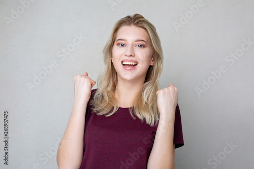 Wallpaper Mural Pretty satisfied blonde girl celebrating success. Space for text Torontodigital.ca