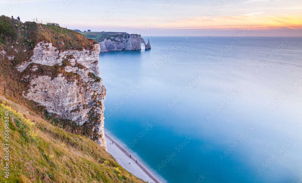 coastal landscape along the Falaise d'Aval the famous white cliffs of Etretat village, with the Porte d'Aval natural arch and the rock known as the Aiguille d'Etretat coastal landscape along the Falaise d'Aval the famous white cliffs of Etretat village, with the Porte d'Aval natural arch and the rock known as the Aiguille d'Etretat