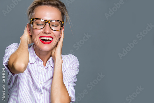 Beautiful woman with short hair and glasses wearing shirt and holding bag