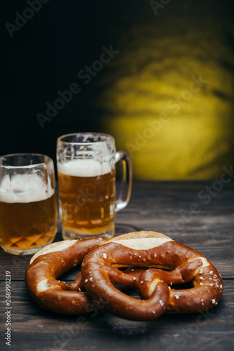 pretzels and beer on wooden table