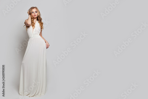 Photography Perfect woman in white dress posing against white background