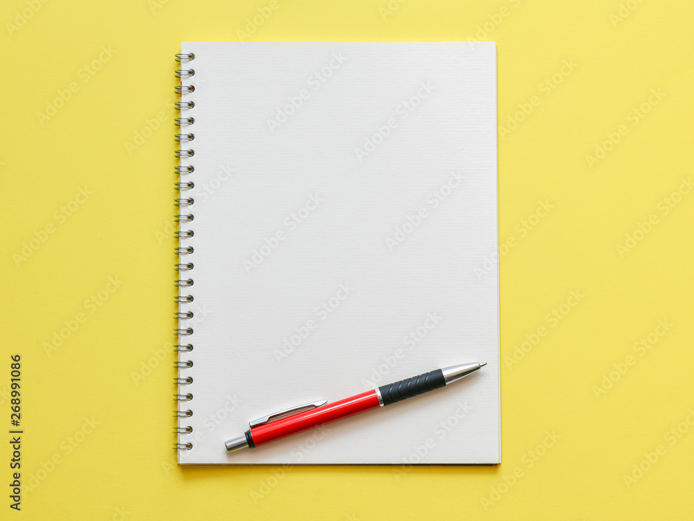 Top view, empty notebook on a yellow background Top view, empty notebook on a yellow background