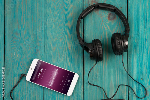 phablet and headphones on the wooden desk photo