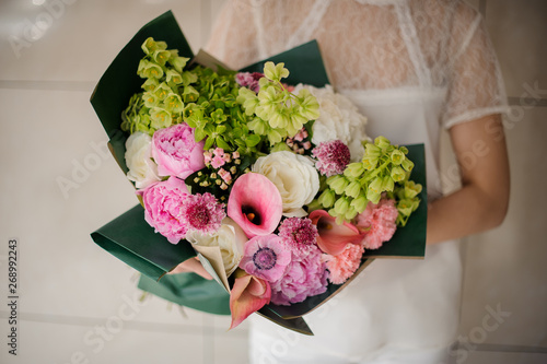 Close shot of girl holding bouquet with various flowers