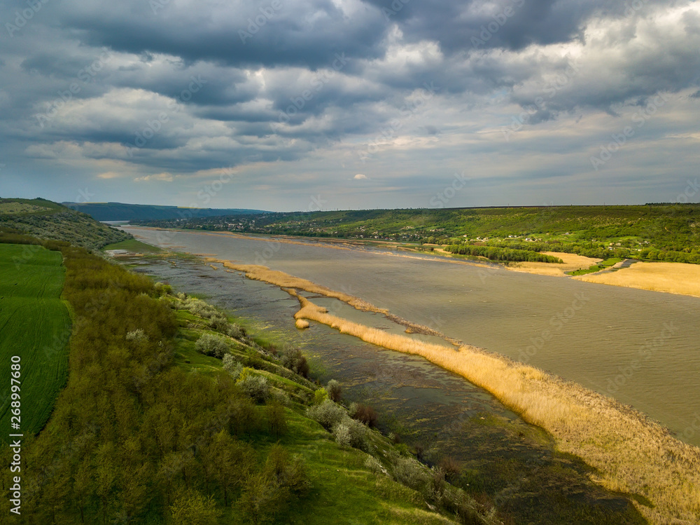 Flight over the river and forest at spring time. Dniester river of Moldova republic.