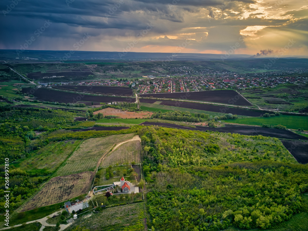 Fototapeta premium Flight over cultivating field in the spring at sunset. Moldova Republic of.