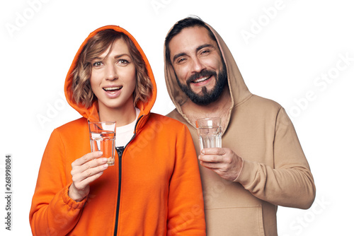 Young couple in home clothes with glass of water