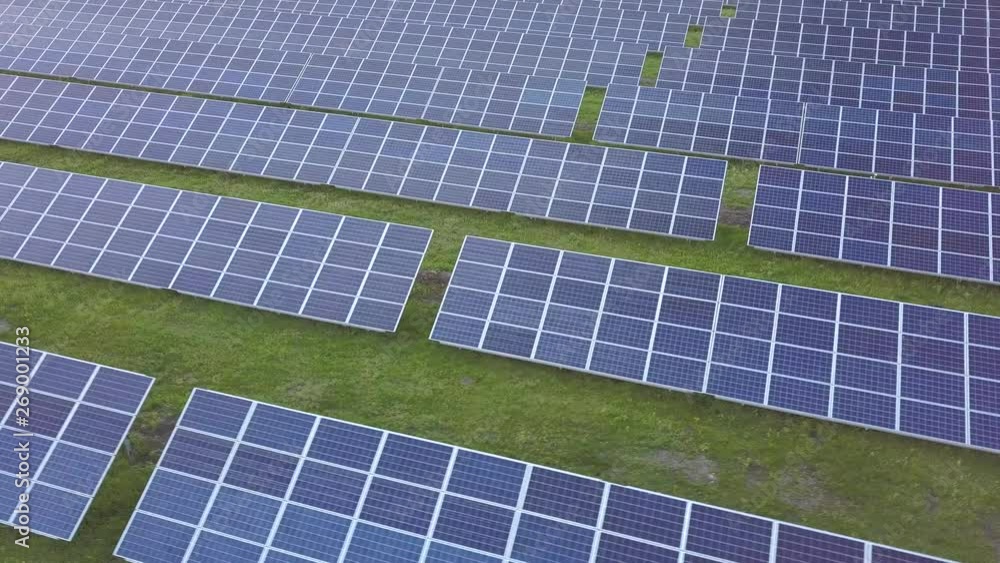 Aerial view of green field with solar energy panels for renewable electricity production. Aerial view of green field with solar energy panels for renewable electricity production.