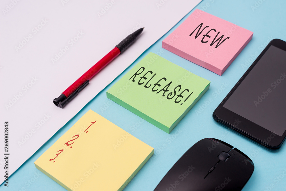 Word writing text New Release. Business photo showcasing announcing something newsworthy recent product Note papers and stationary plus gadgets placed sideways above backdrop Word writing text New Release. Business photo showcasing announcing something newsworthy recent product Note papers and stationary plus gadgets placed sideways above backdrop