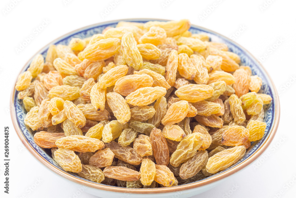 Dried grape or golden raisins in bowl on white background Dried grape or golden raisins in bowl on white background