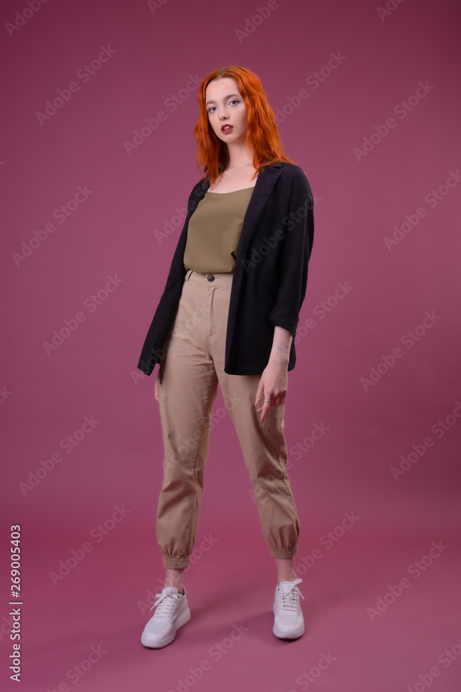 Full length portrait of a young girl standing over pink background Full length portrait of a young girl standing over pink background