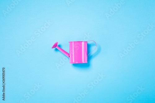Pink lady lie on pastel blue background. Minimal summer concept.