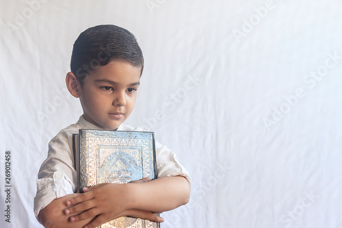 Canvas Print A young middle eastern boy with The Holy Quran