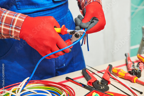 Electrician works with cable photo