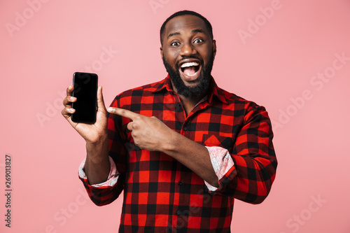 Portrait of a happy casual african man standing isolated