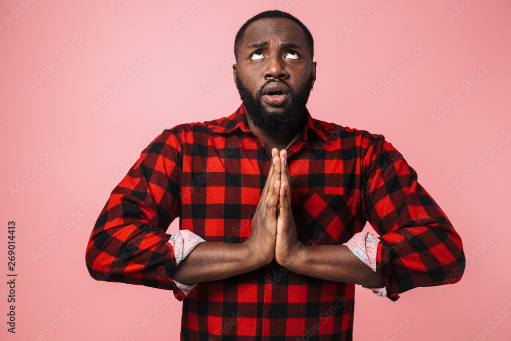 Portrait of a worried african man wearing plaid shirt Portrait of a worried african man wearing plaid shirt