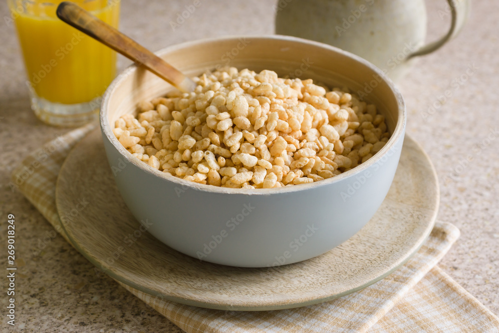 Puffed rice breakfast cereal in a wooden bowl Puffed rice breakfast cereal in a wooden bowl