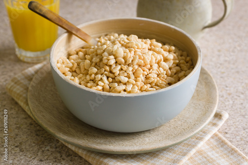 Puffed rice breakfast cereal in a wooden bowl