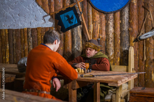 Two men playing popular strategy board game - tafl