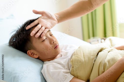 Young boy sick and sleep on the bed
