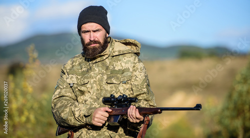Hunting masculine hobby. Man brutal gamekeeper nature background. Bearded hunter spend leisure hunting. Hunter hold rifle. Focus and concentration of experienced hunter. Hunting and trapping seasons