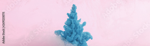 Close up view of blue paint splash isolated on pink