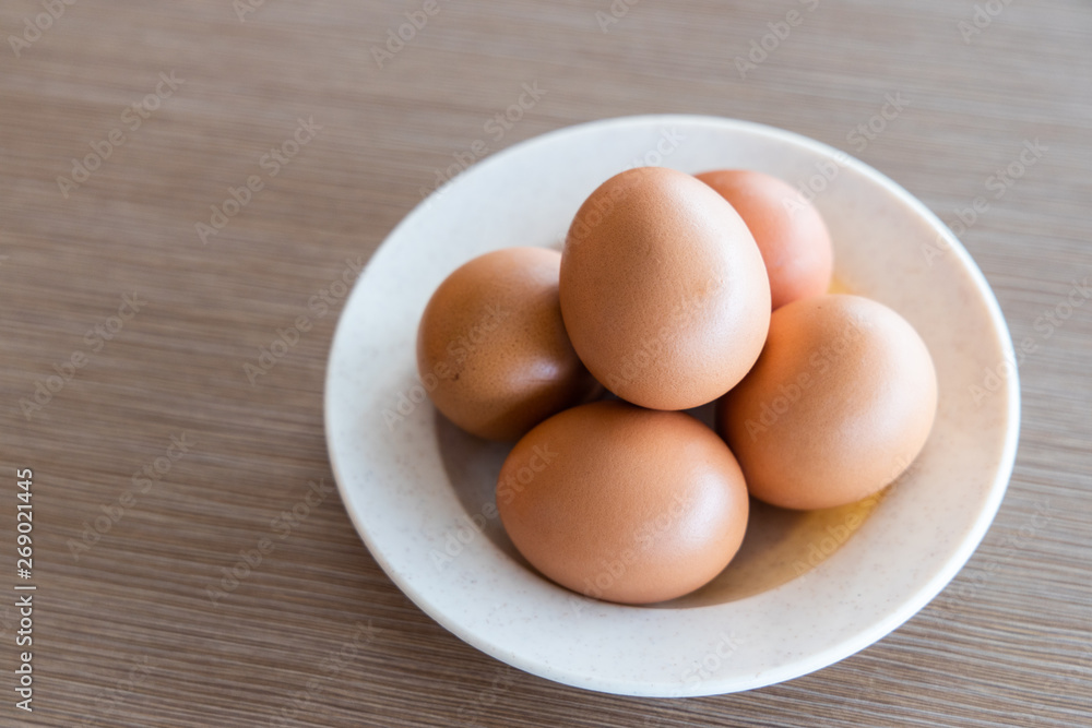 Farm fresh organic chicken eggs on plate with natural light Farm fresh organic chicken eggs on plate with natural light