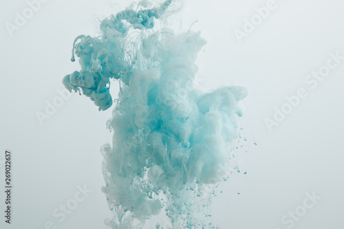 Close up view of light blue paint swirls isolated on grey