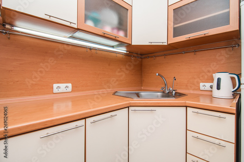The photo of a sink in a The photo of a sink in a kitchen