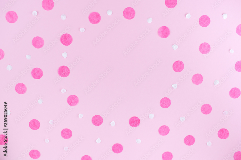 Pink background with pink round confetti. Festive background for your design. Flat lay style.
