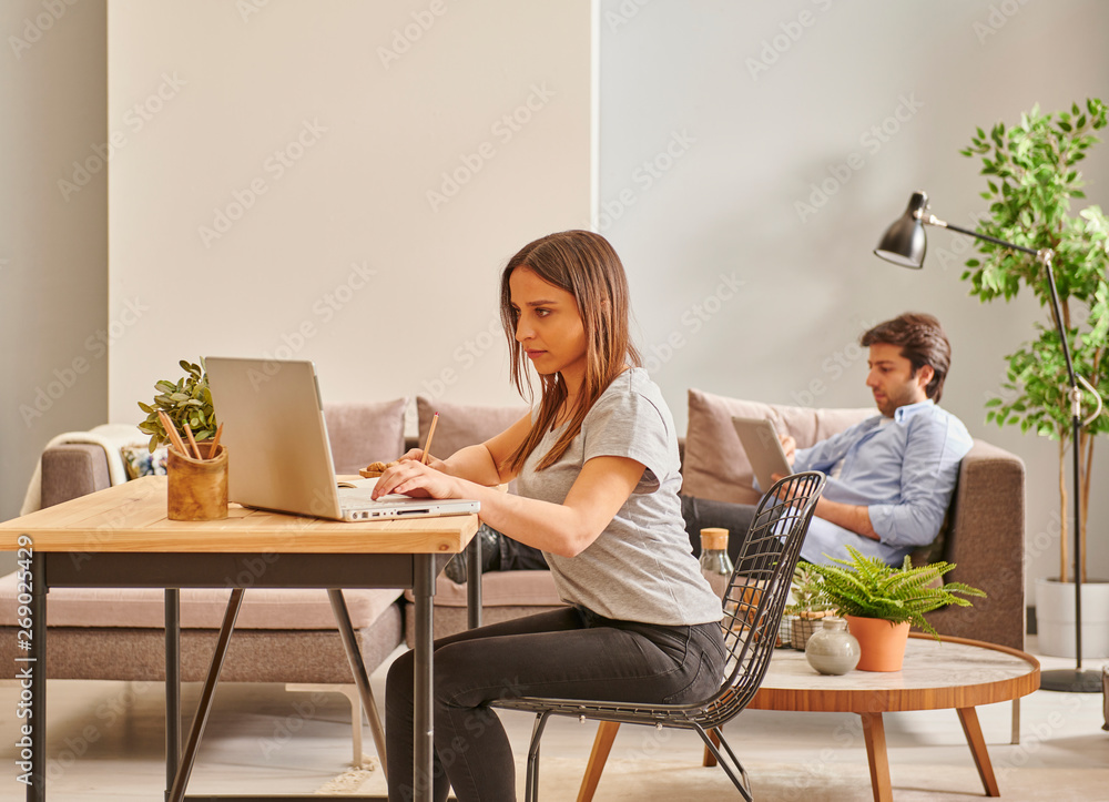 Couple at the same house, working and living room. Couple at the same house, working and living room.