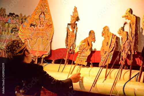 a puppeteer when playing a shadow puppet on a stage photo