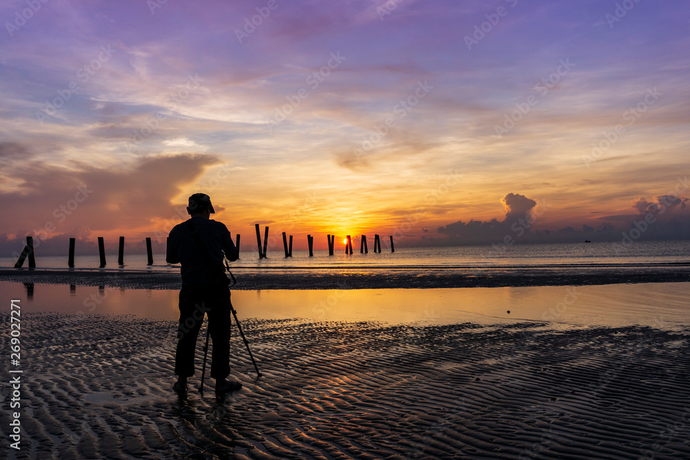 Photographers during sunrise on the beach
