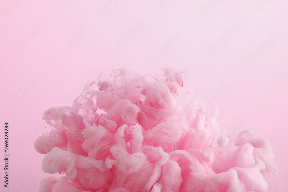 Close up view of pink paint swirls in water isolated on pink Close up view of pink paint swirls in water isolated on pink