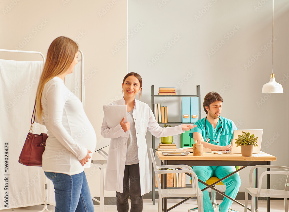 Pregnant woman is coming to doctor clinic. Baby control day in hospital. Pregnant woman is coming to doctor clinic. Baby control day in hospital.