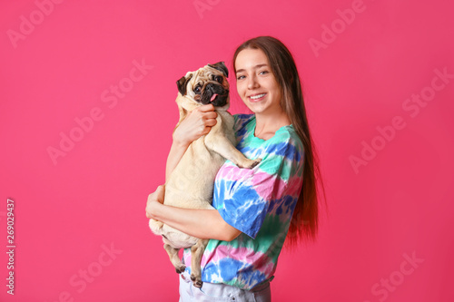 Teenage girl with cute pug ...