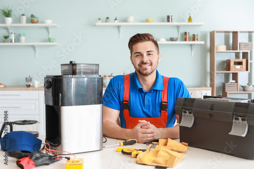 Man repairing coffee machin...