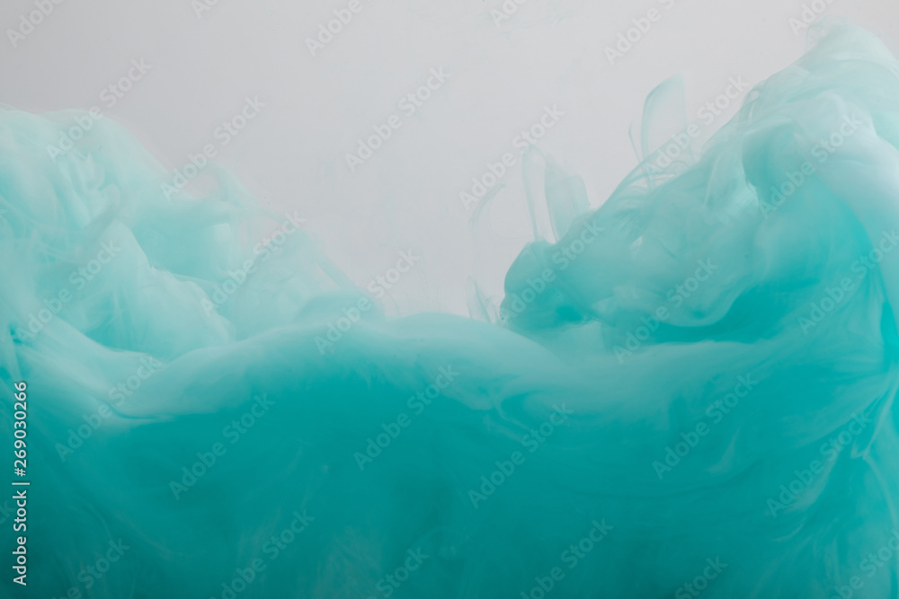 Close up view of turquoise paint swirls isolated on grey Close up view of turquoise paint swirls isolated on grey