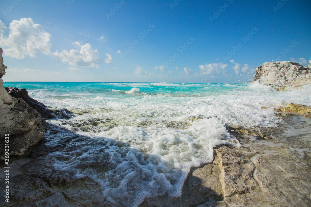 Cancun beach. The caribbean sea beats against the rocks