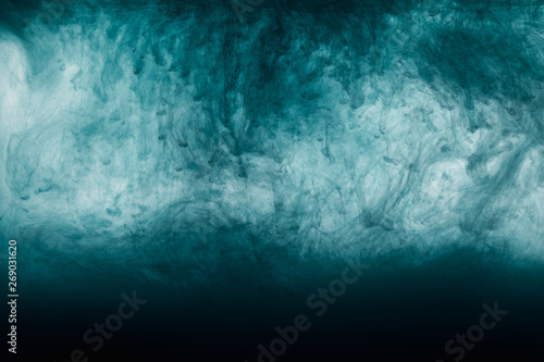 dark artistic blue paint swirls in water